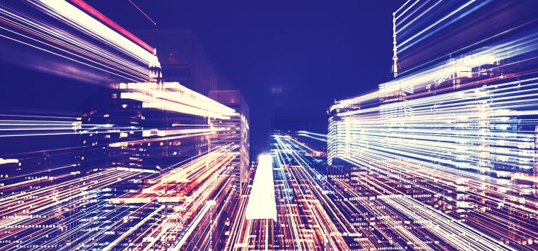 New York City night skyline with futuristic zoom effect.